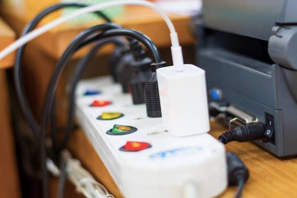 A bunch of wires are plugged into a power strip.