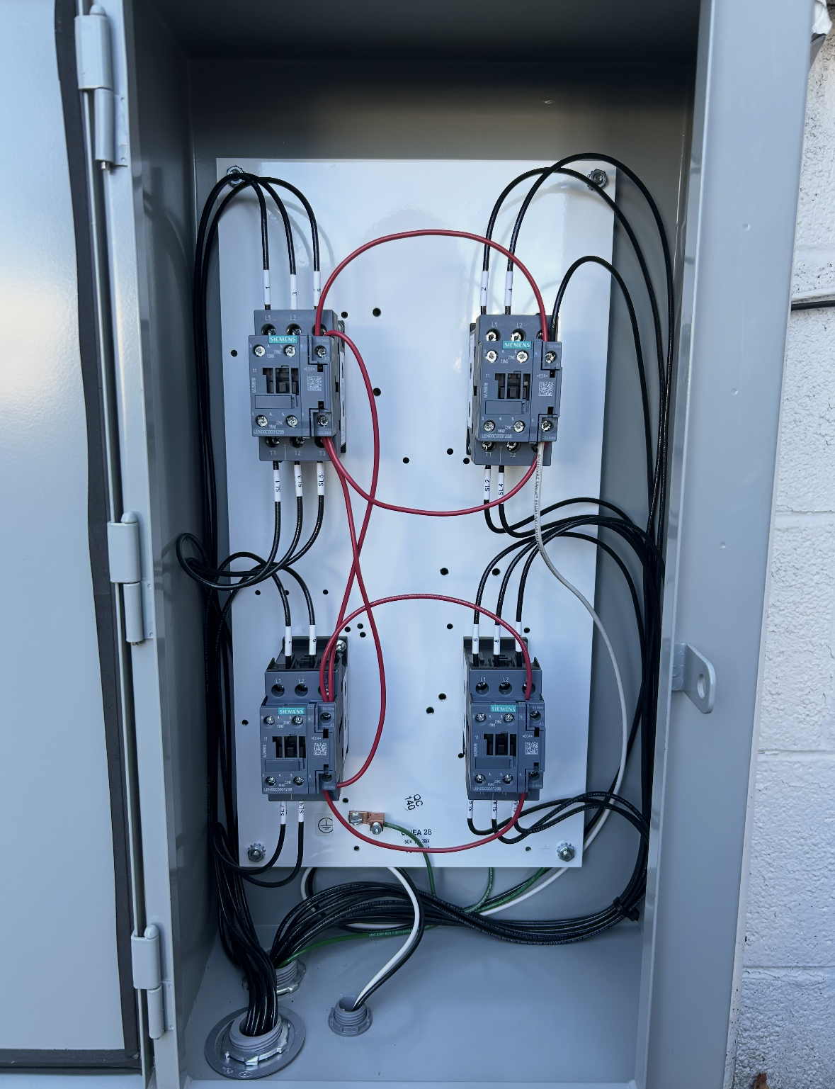 Inside a white electrical box: various wires, circuits, and terminals connected to electronic components.