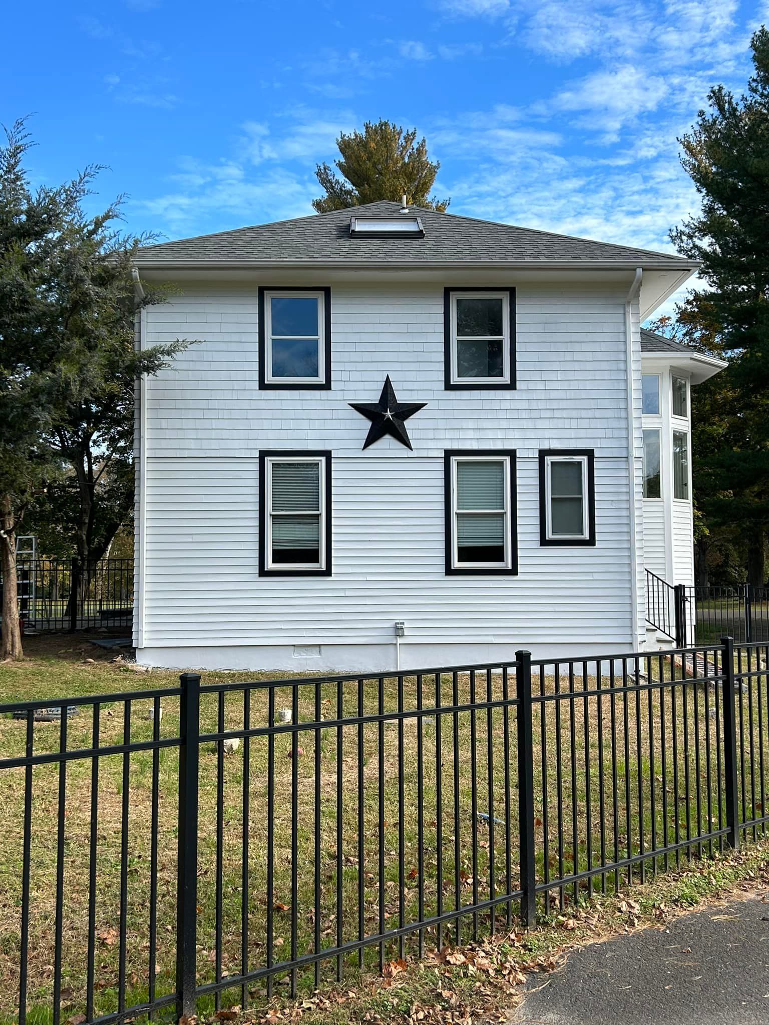 A white house with a black star on the side