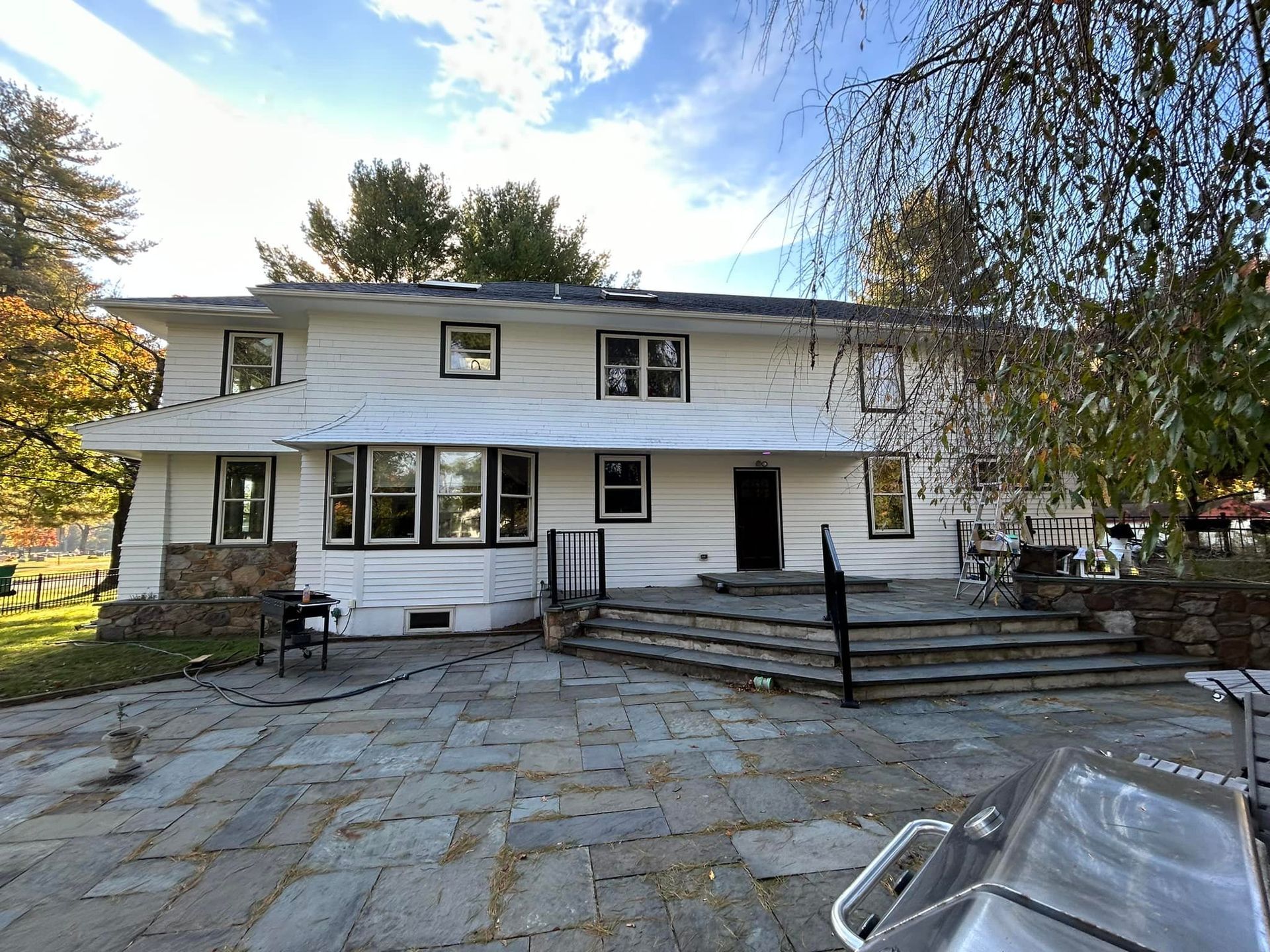 A large white house with a patio in front of it.
