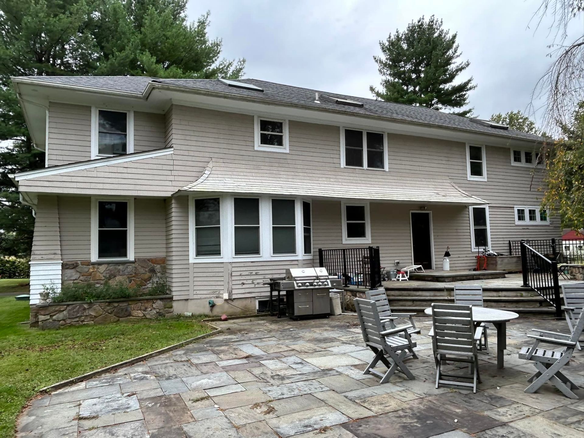 A large house with a patio area in front of it.