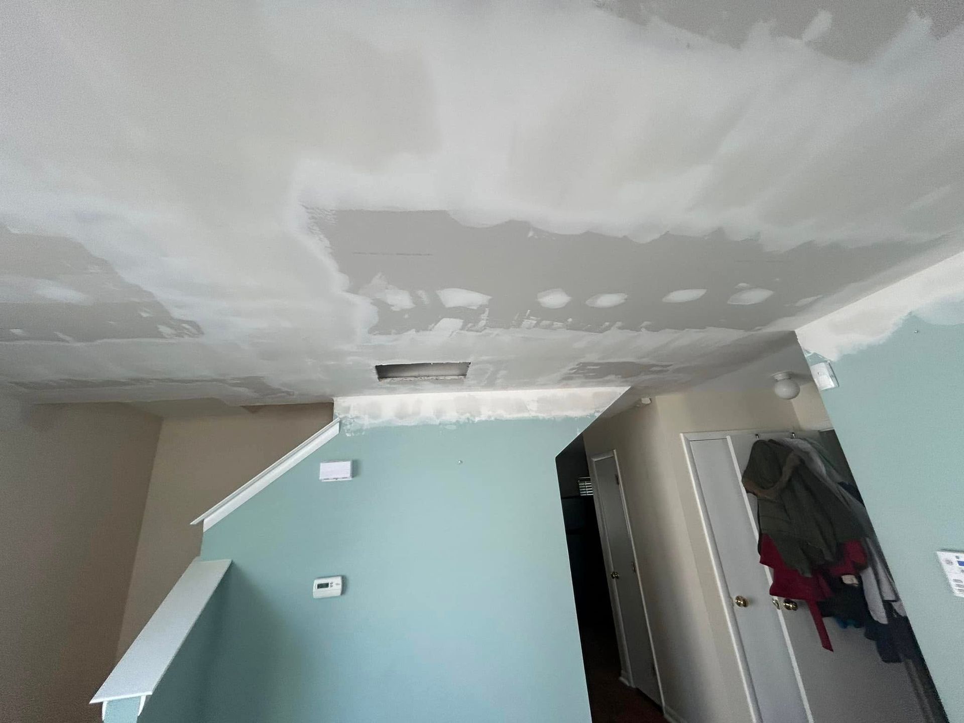 A room with a ceiling that has a hole in it