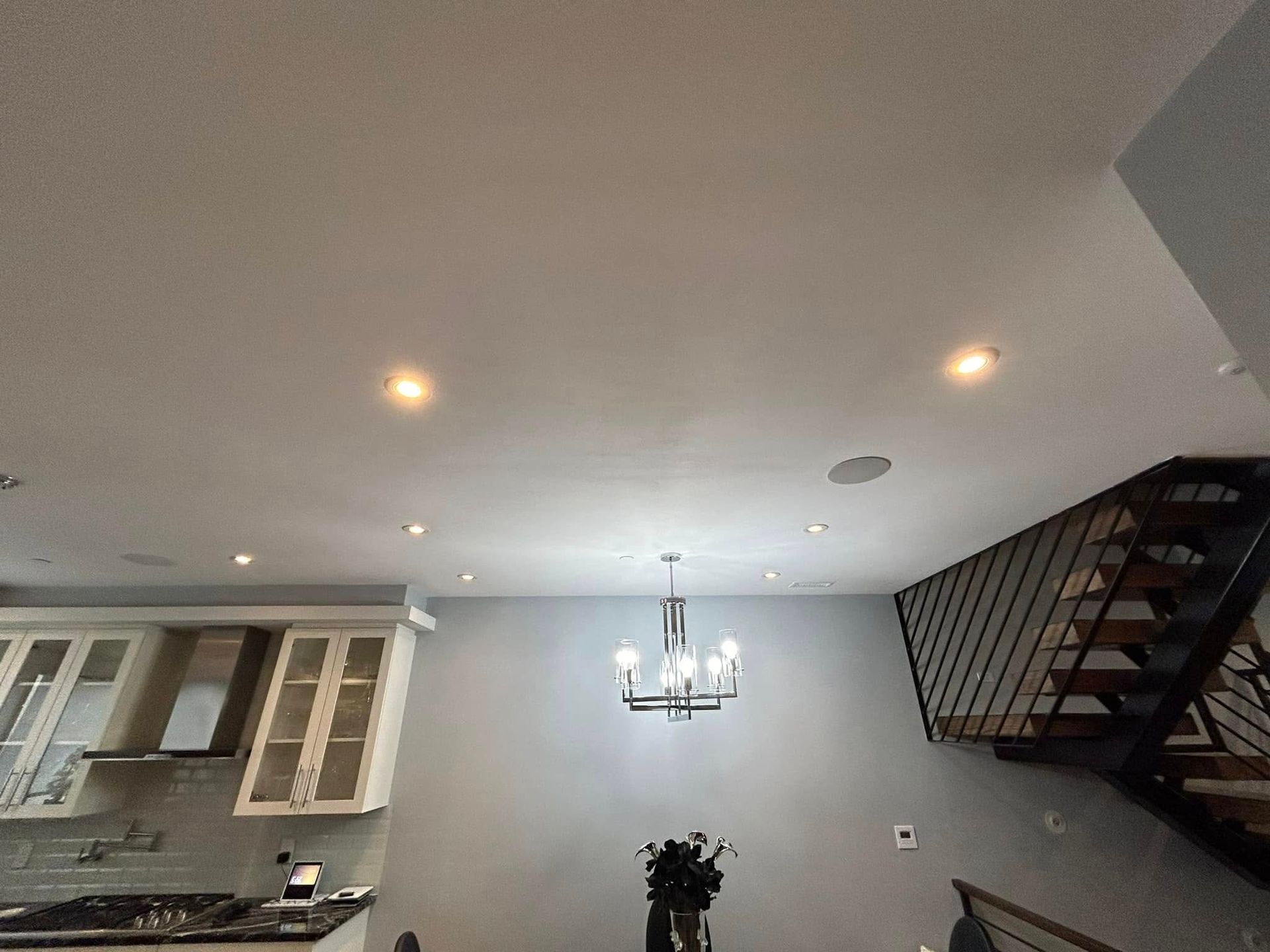 A kitchen with a chandelier hanging from the ceiling