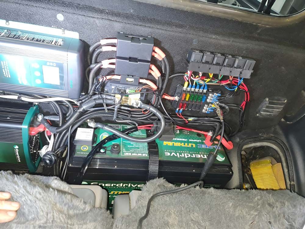 A Bunch Of Wires Are Coming Out Of The Trunk Of A Car — Ballarat Auto Sparky in Sebastopol, VIC