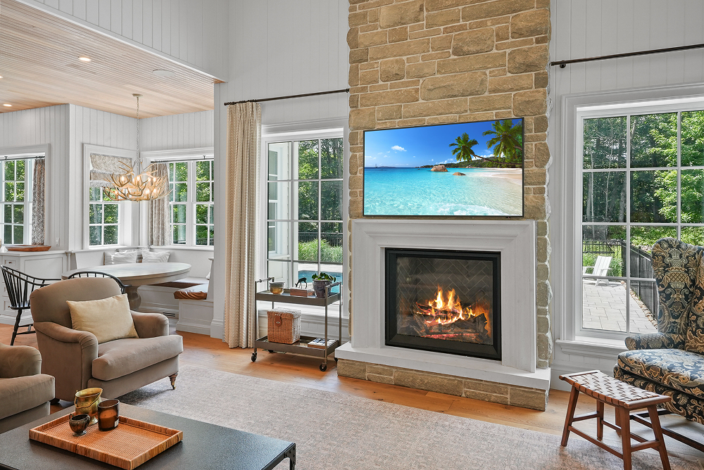 A living room with a fireplace and lots of windows