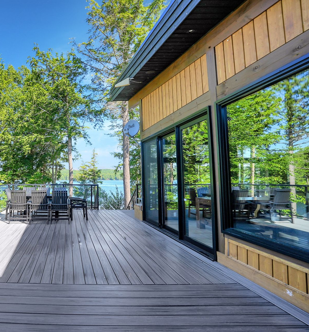 A small house is sitting on the shore of a lake.
