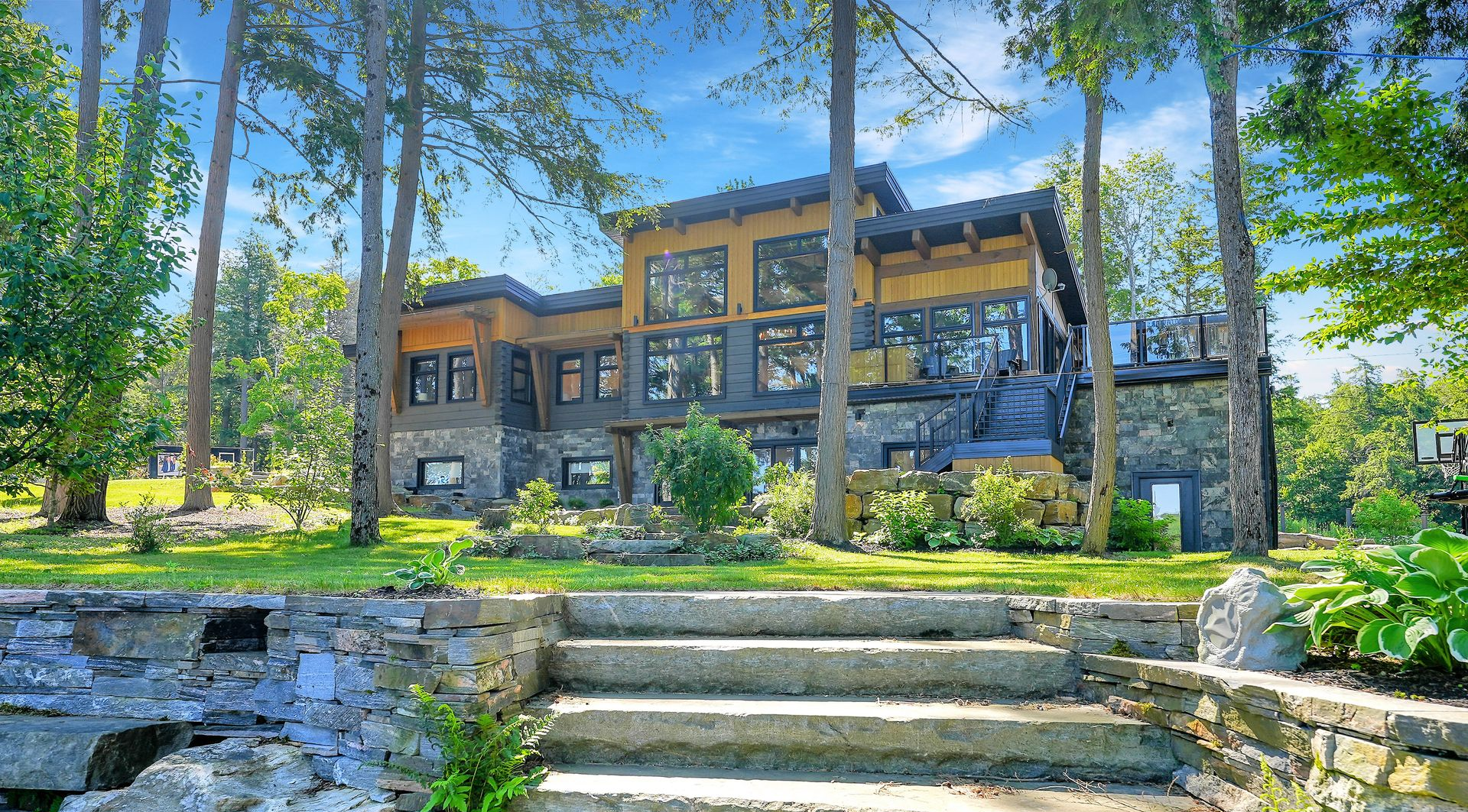 A large house is surrounded by trees and bushes