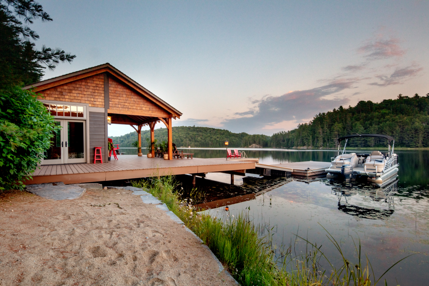 A boat is docked at a dock next to a house
