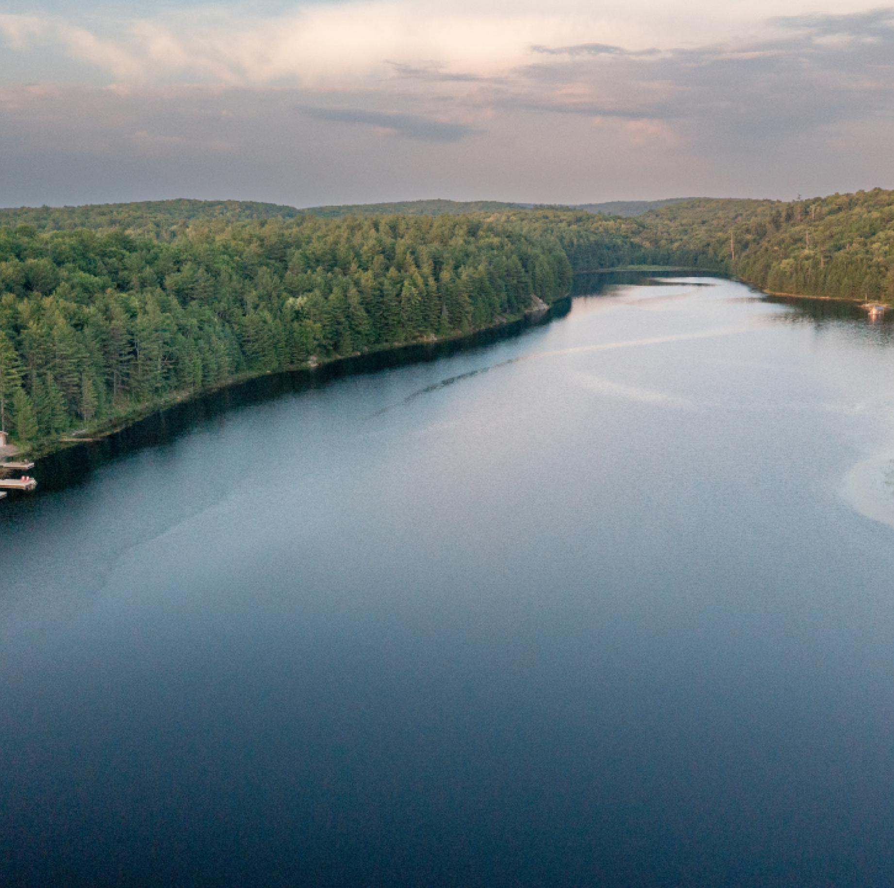 An aerial view of a large body of water surrounded by trees.