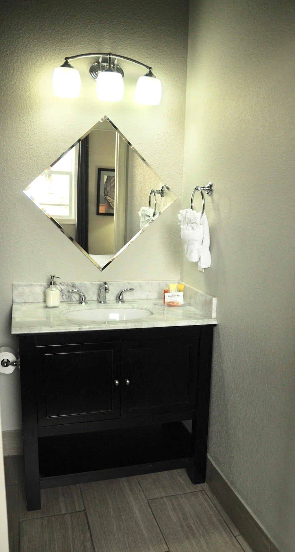 A bathroom with a sink , mirror and toilet.