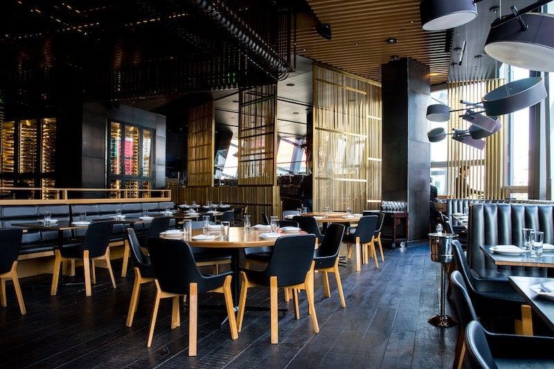 A large dining room with tables and chairs in a restaurant.