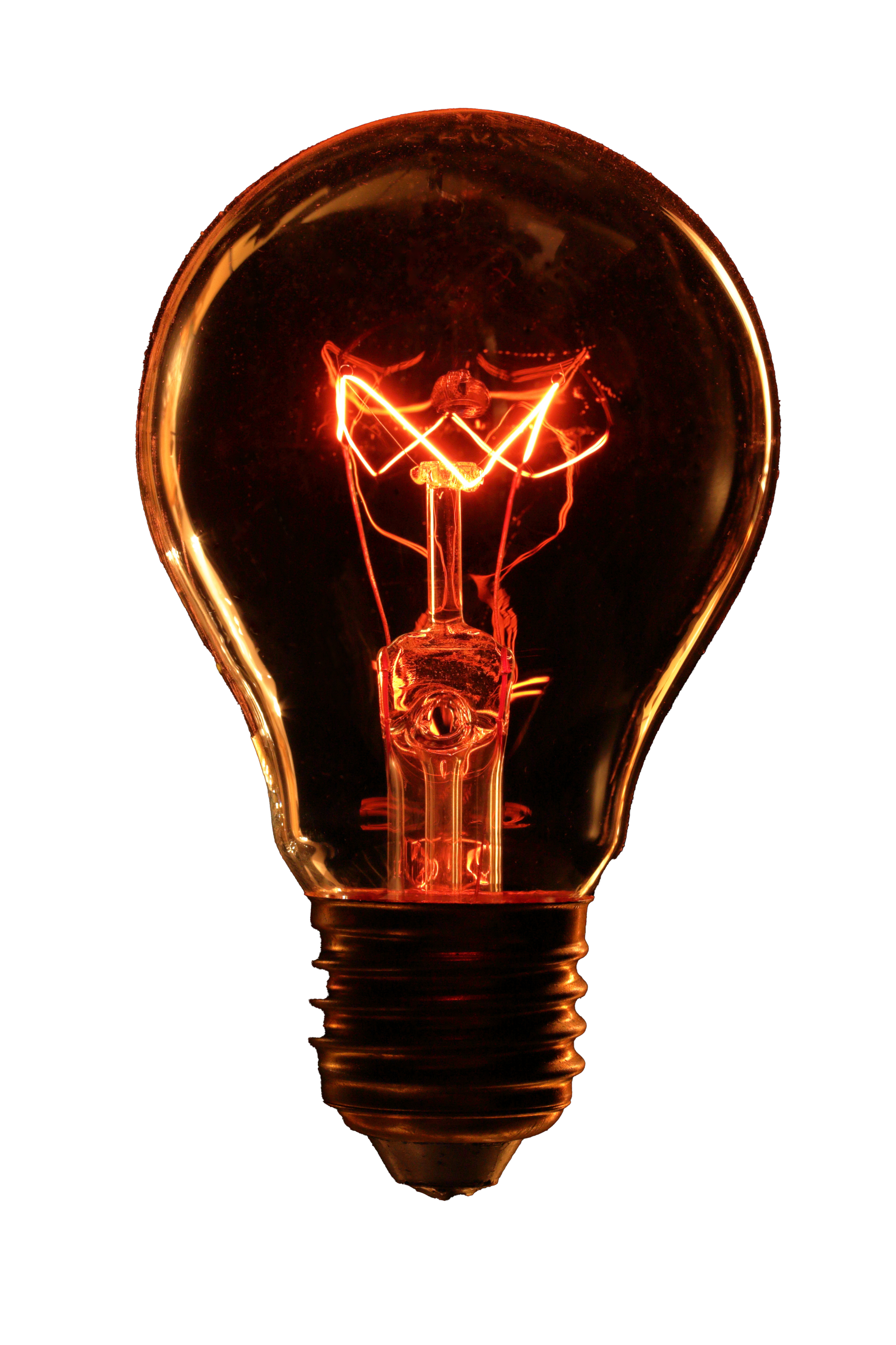 Glowing incandescent light bulb. Orange filament illuminated inside glass bulb with a black base.