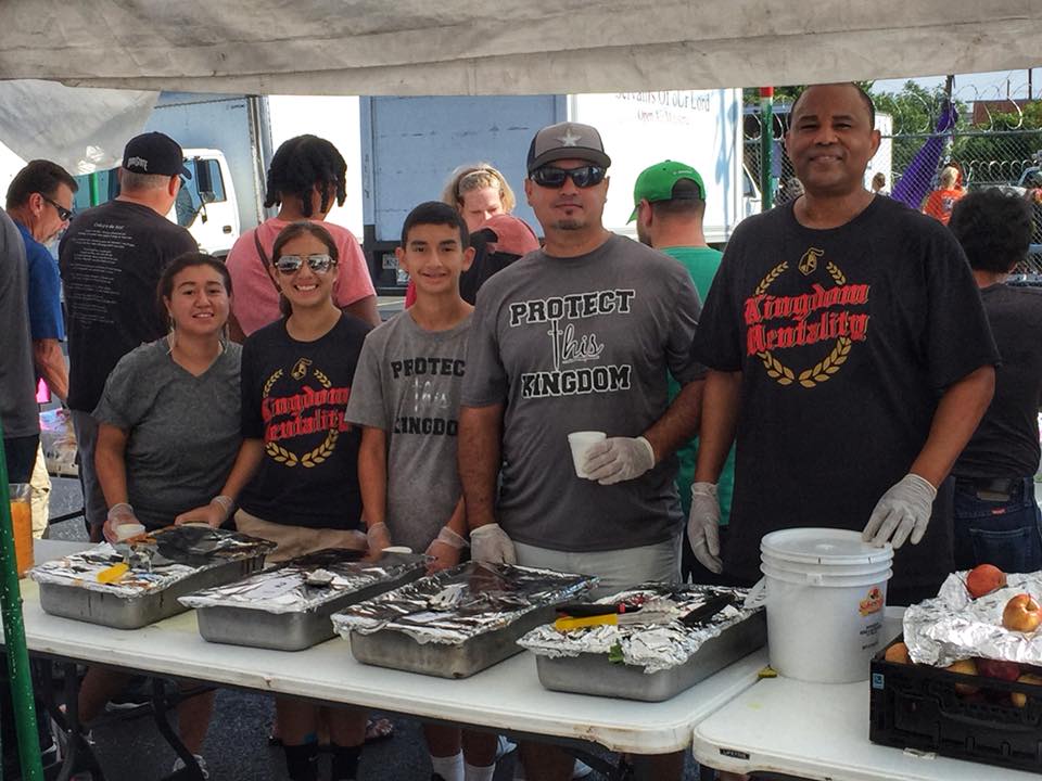 People at a food stand, wearing