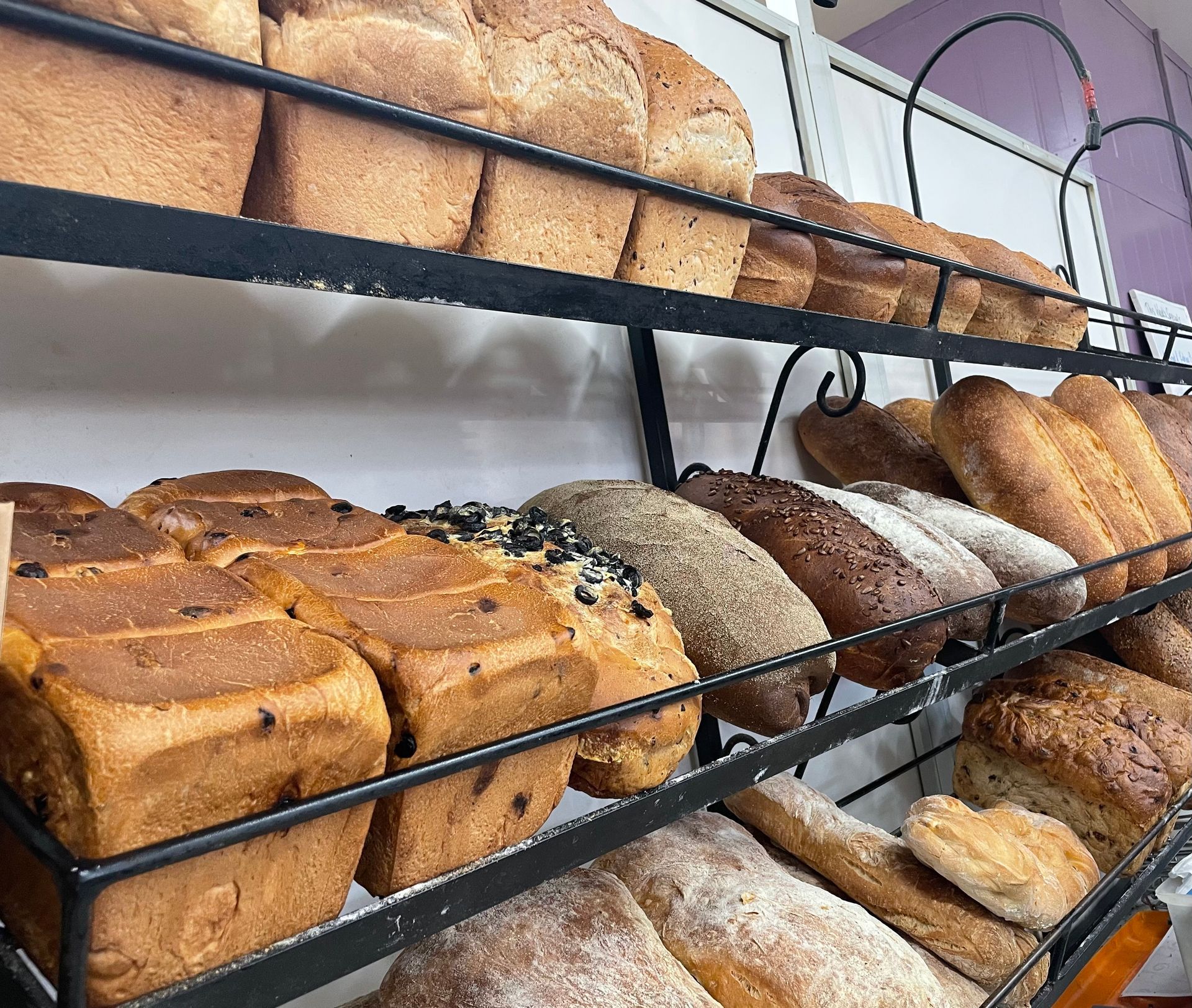 A large shelf of freshly baked bread— Bread Basket in Kurri Kurri, NSW
