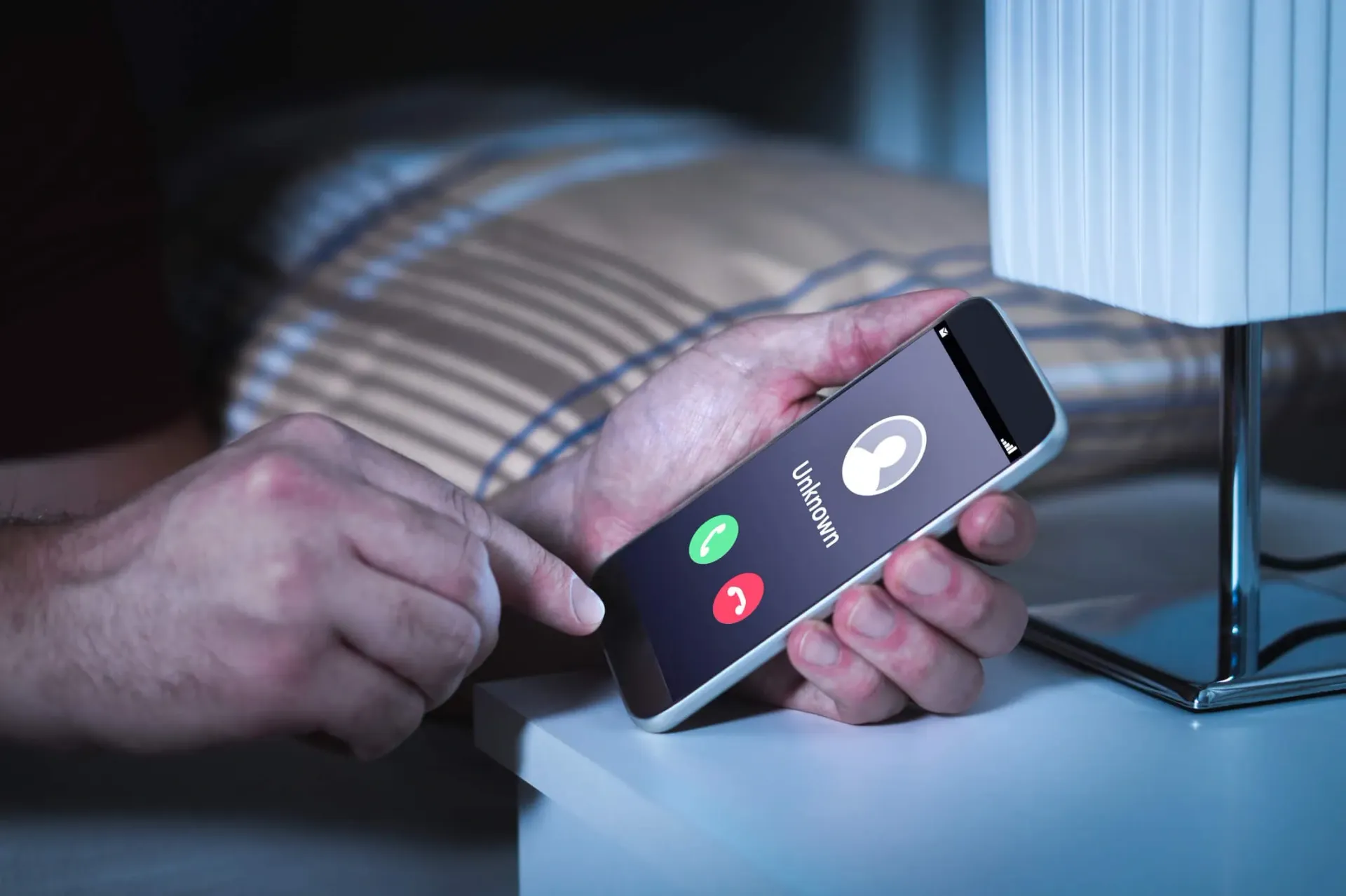 A person receives a call from an unknown number on their smartphone 