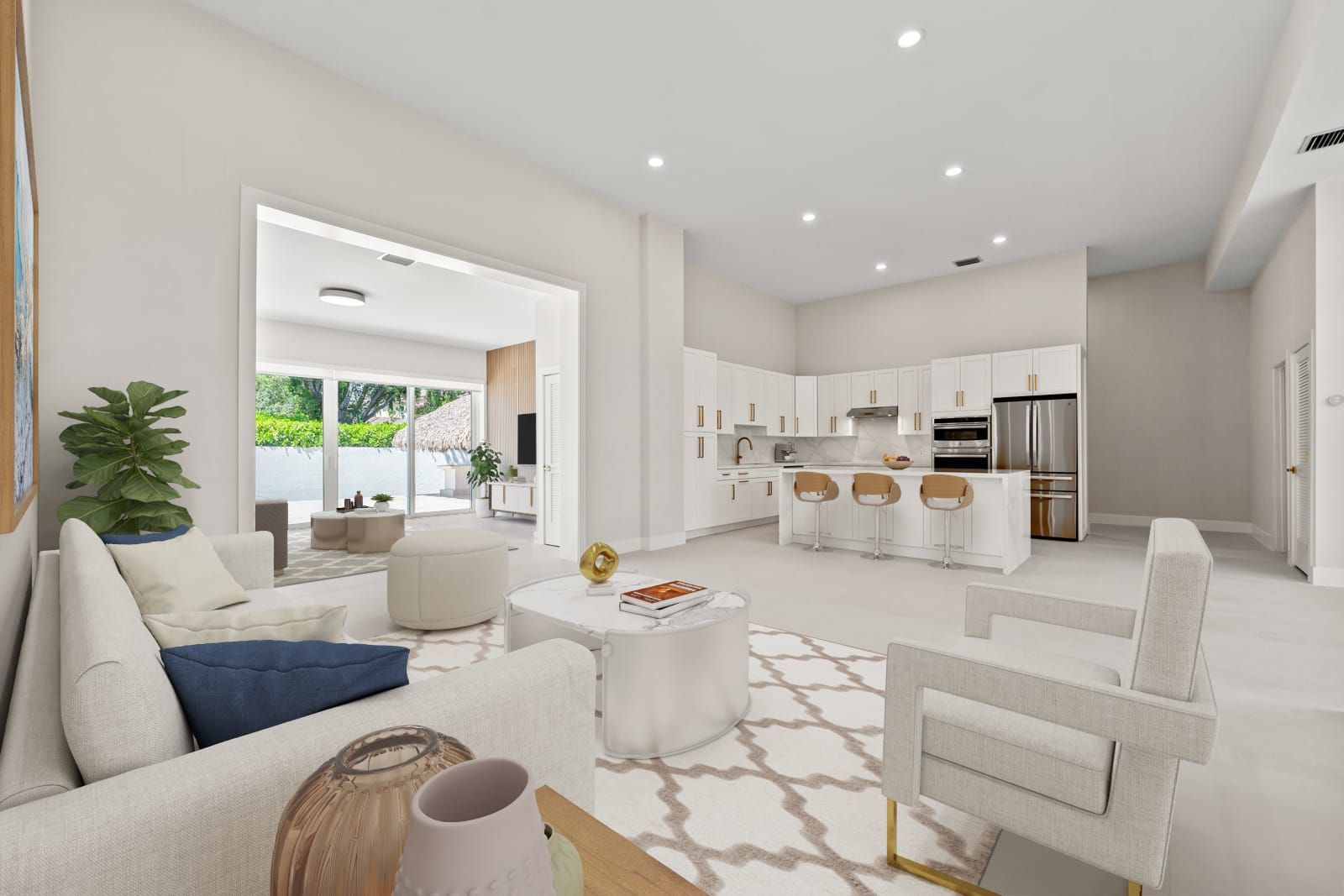 Bright modern open-plan living room and kitchen with white furniture and large windows.