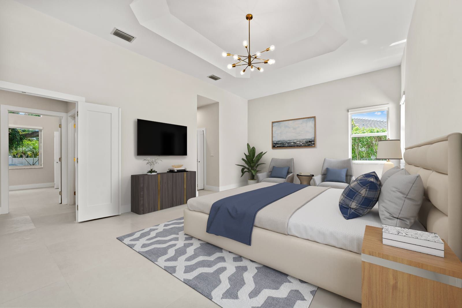 Bright modern bedroom with a large bed, wall TV, chandelier, and soft gray-blue decor
