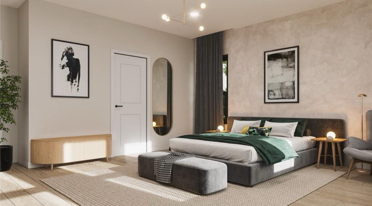 Modern minimalist bedroom with a gray bed, beige walls, framed art, and warm lighting.