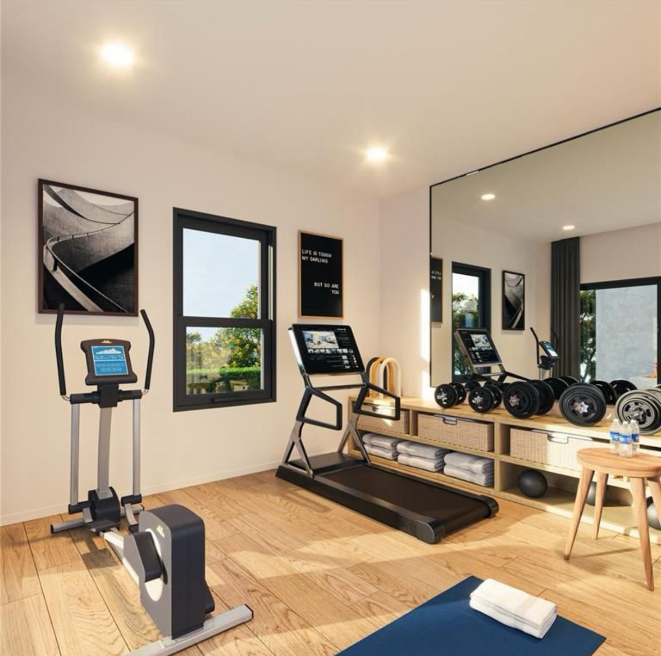 Modern home gym with treadmill, exercise bike, weights, and large wall mirror, in a bright room
