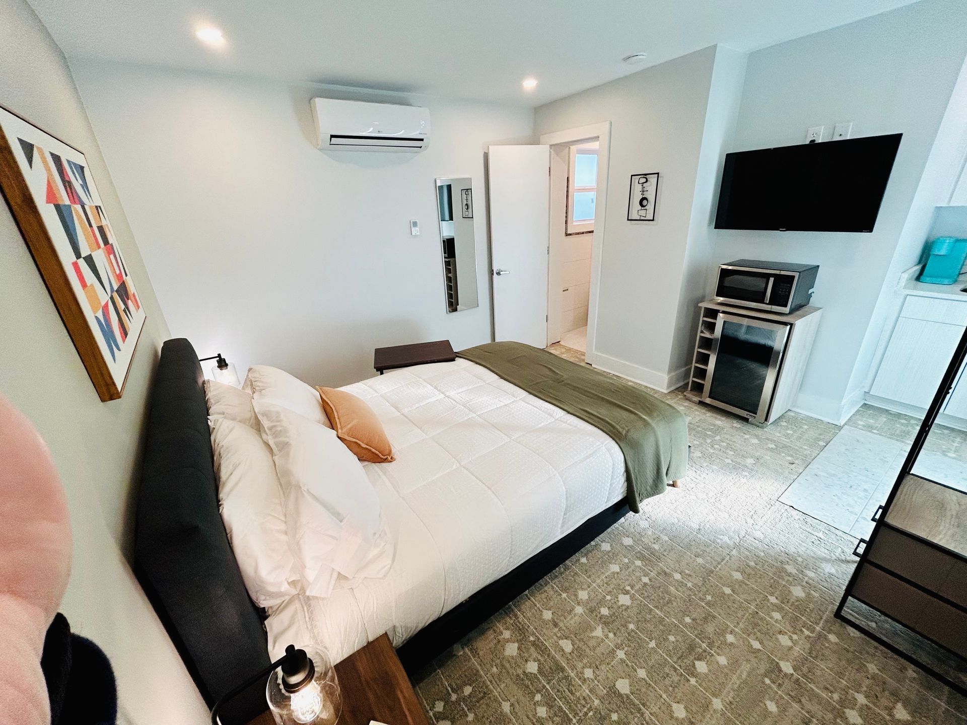 a bedroom with a king size bed and a flat screen tv .