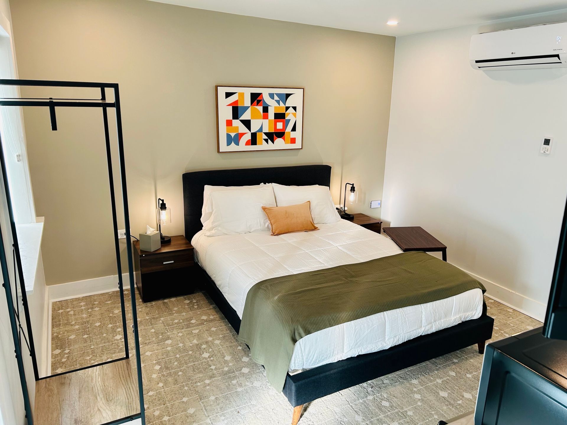 a bedroom with a king size bed , nightstands , and a television .