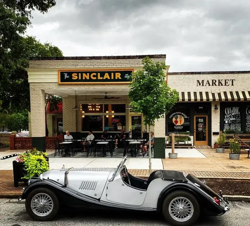 a car is parked in front of a sinclair market