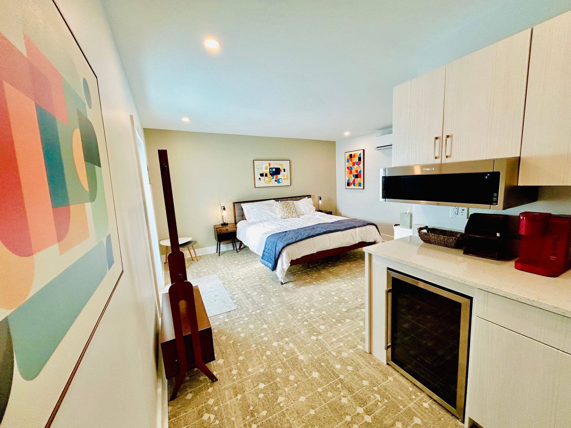 a bedroom with a king size bed and a kitchen