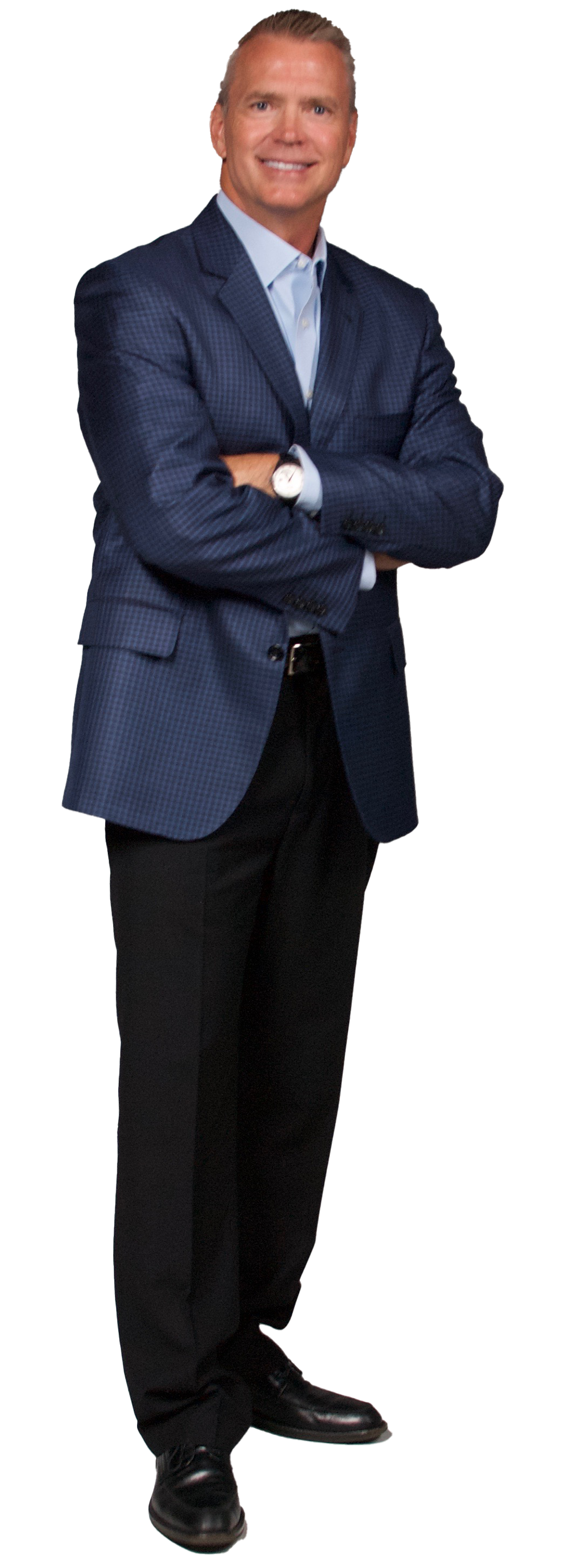A man in a blue suit and black pants is standing with his arms crossed.