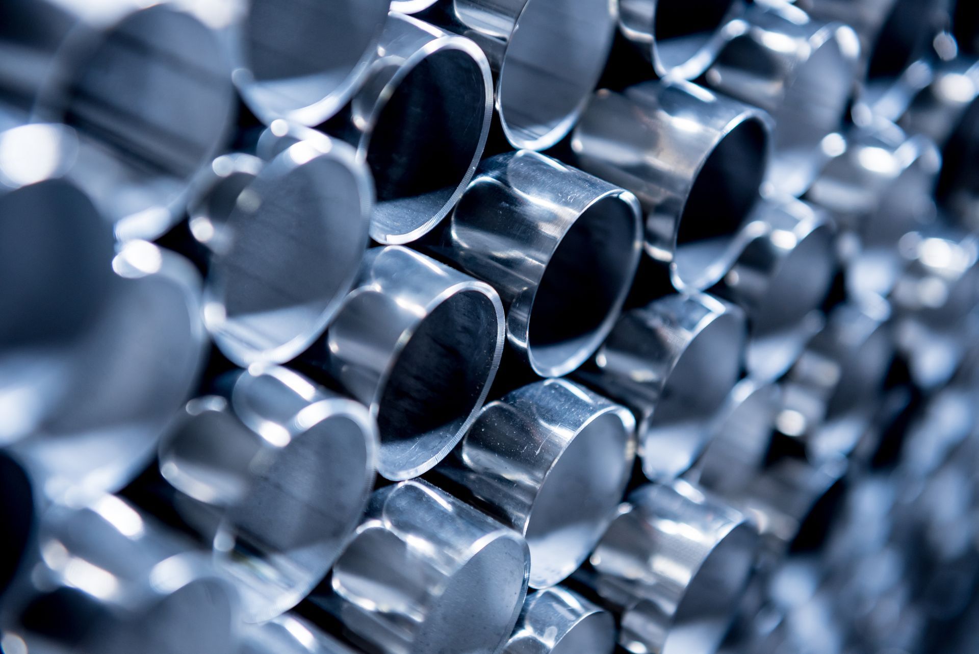 Stacked metal pipes bundled for processing at a modern stainless steel recycling center. Stacked metal pipes bundled for processing at a modern stainless steel recycling center.