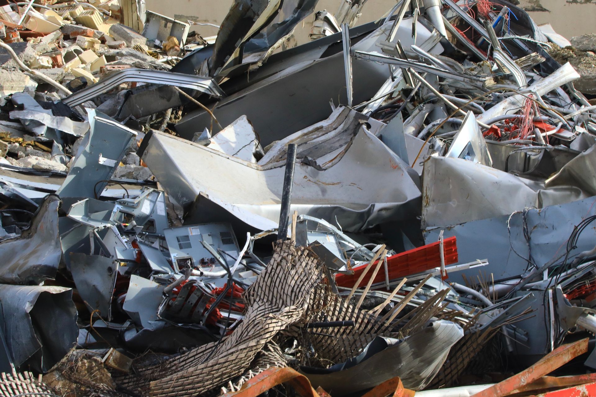 A large pile of recycled steel debris sorted for processing at a metal recycling center.