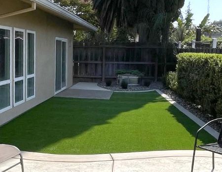 A house with a large lawn in front of it