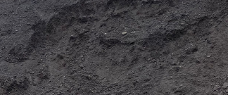 A close up of a pile of black soil.
