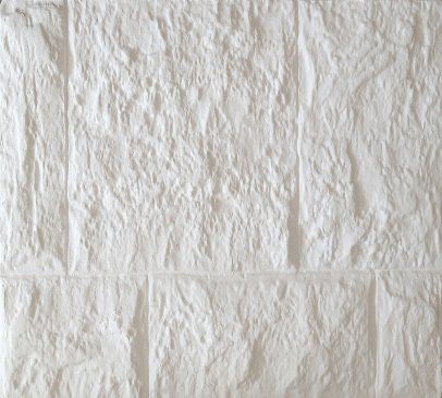 Pared texturizada de color blanco con patrón similar al ladrillo.