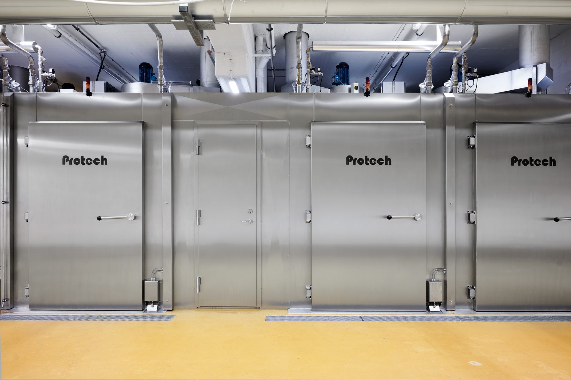 A row of stainless steel doors with protech written on them