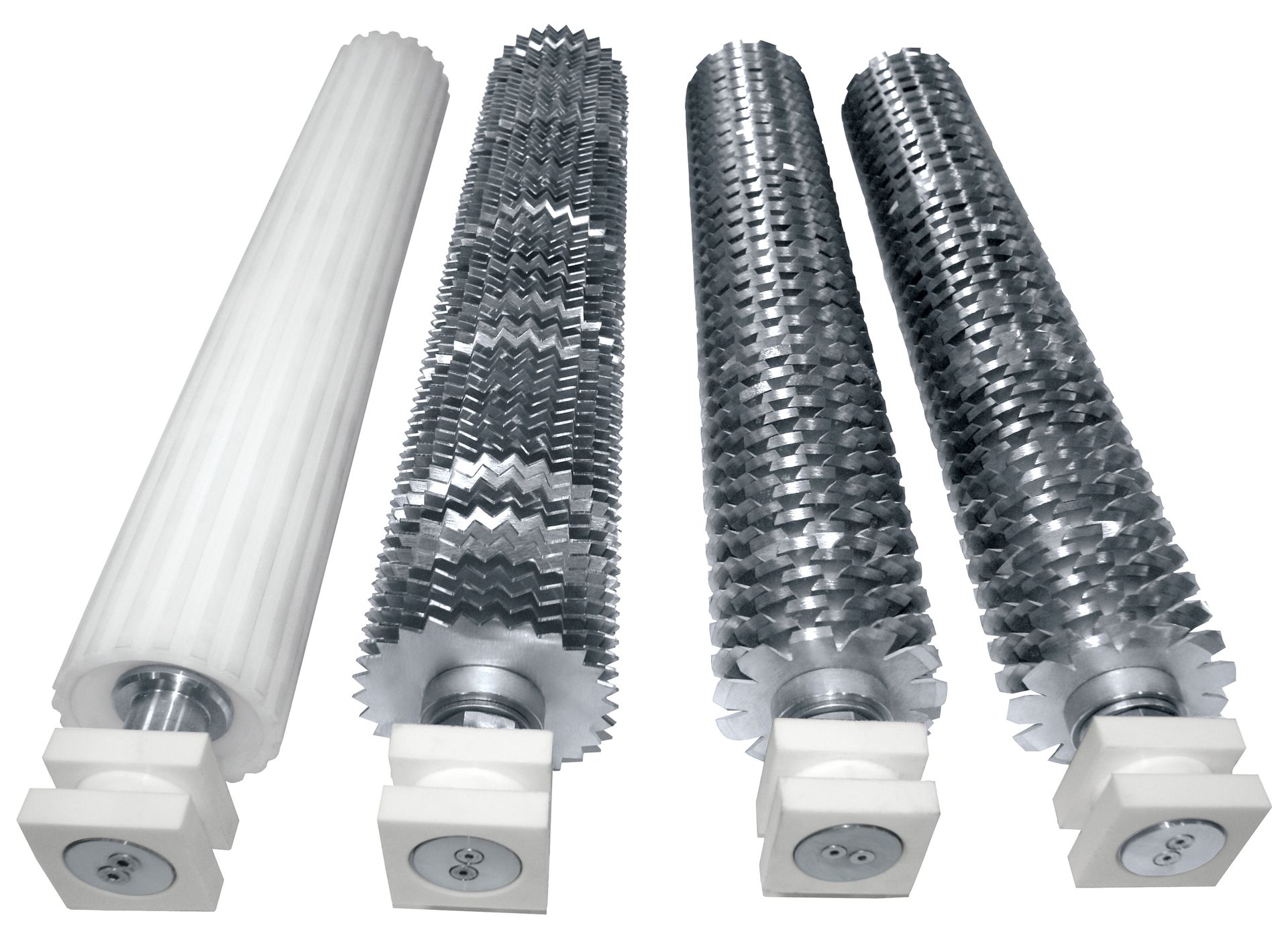 Four brushes are lined up next to each other on a white surface.