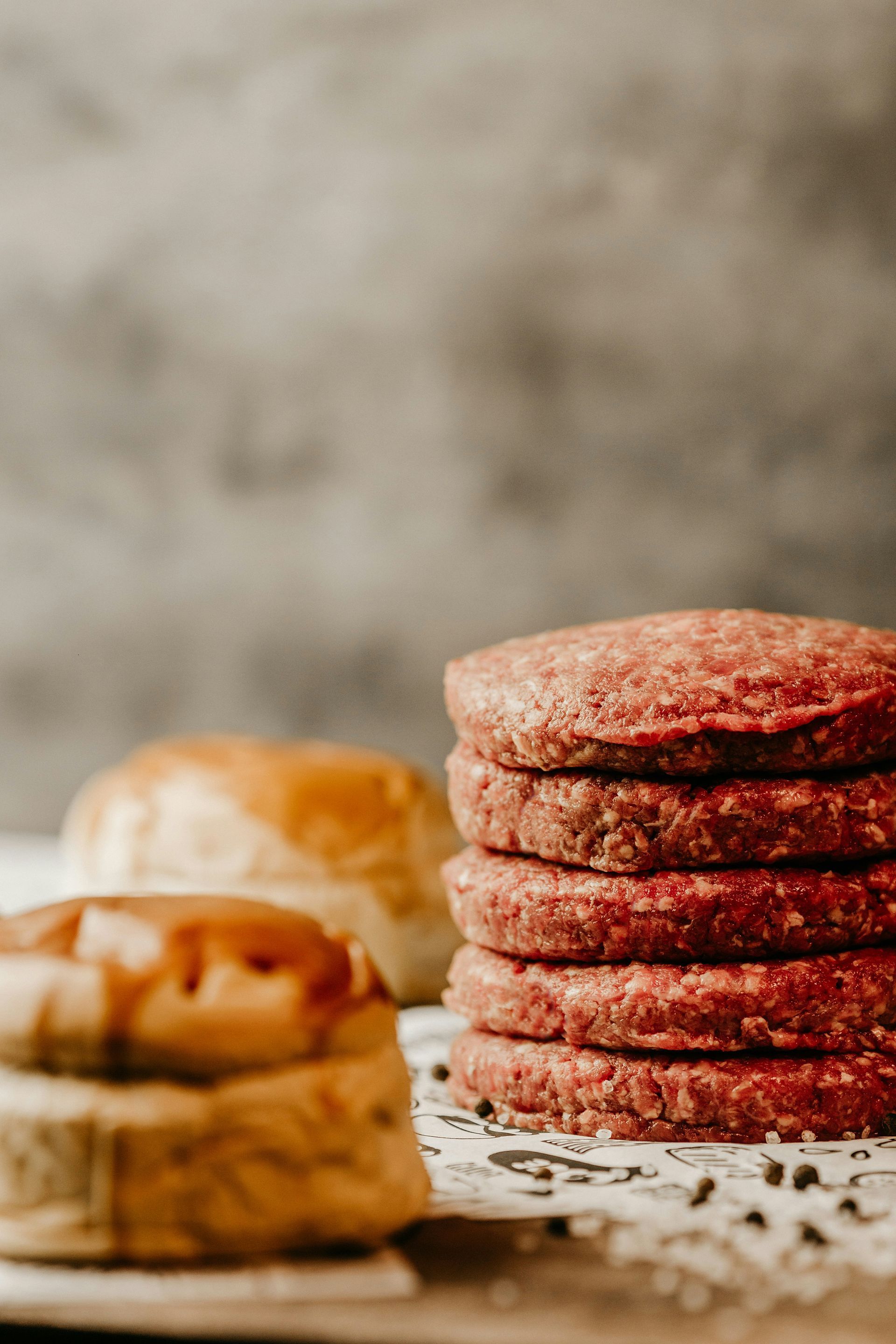 A stack of hamburger patties sitting on top of each other on a table.