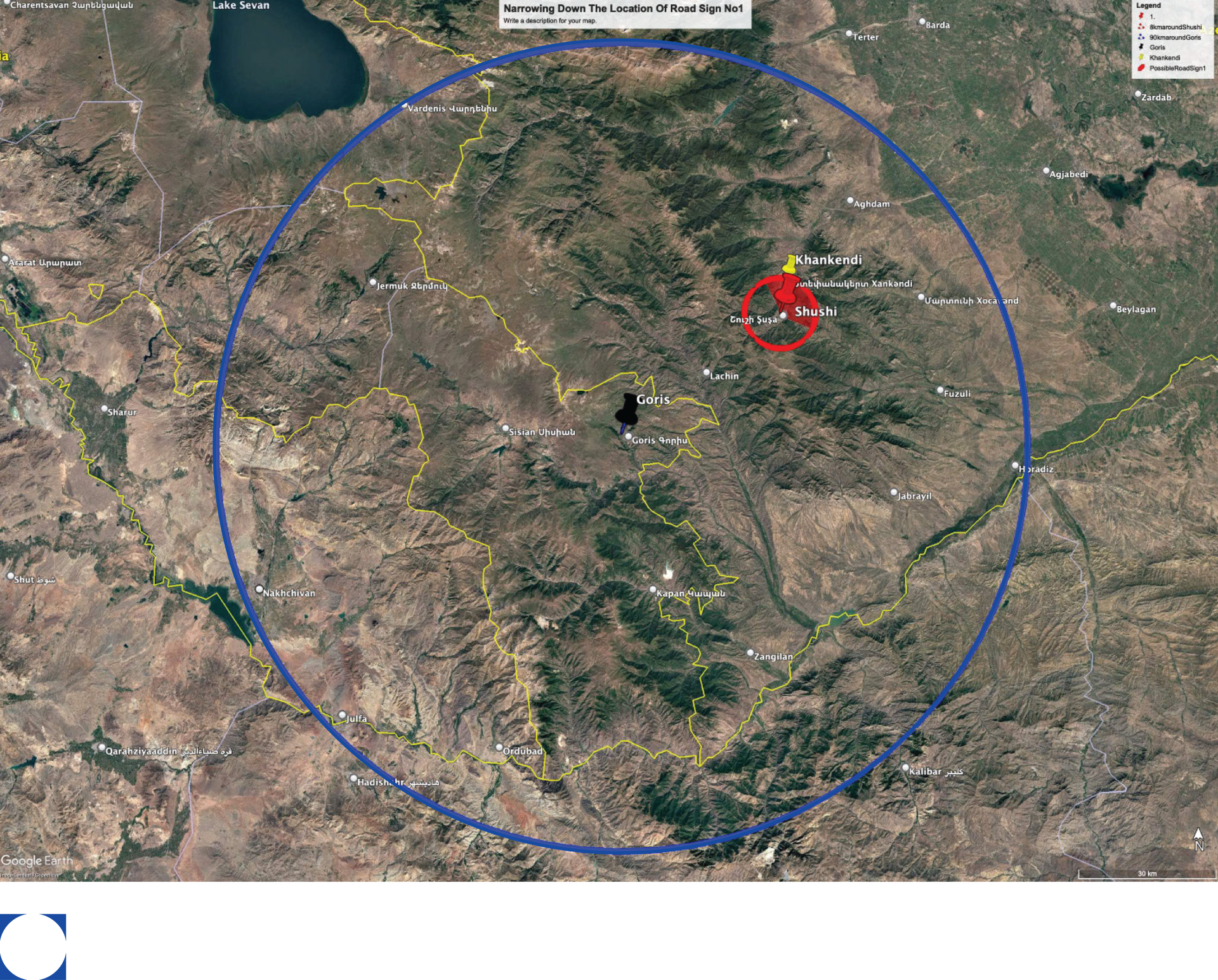 Satellite view of a landscape with a blue circle, red circle, and black dot marking locations, featuring mountains.