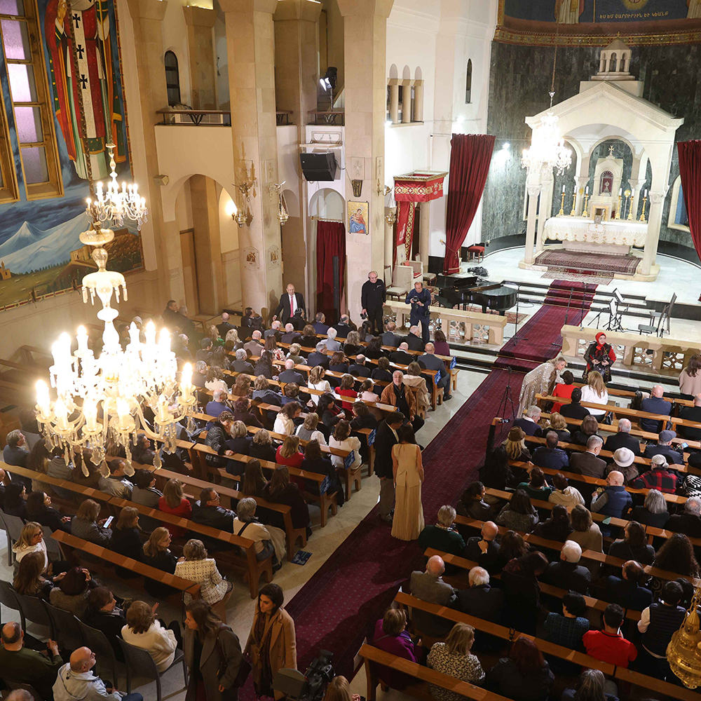 Interior view of a church filled with people seated on pews during Giving Voice to Hope concert in Beirut