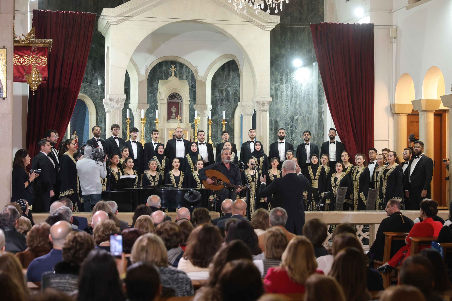 Fayha Choir performing in a church before an audience Maestro Barkev conducting, Ziad Ahmadieyh playing oud.
