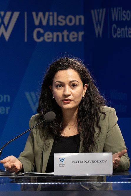 Natia Navrouzov Yazda’s Executive Director speaking at a Wilson Center event, wearing a green blazer.