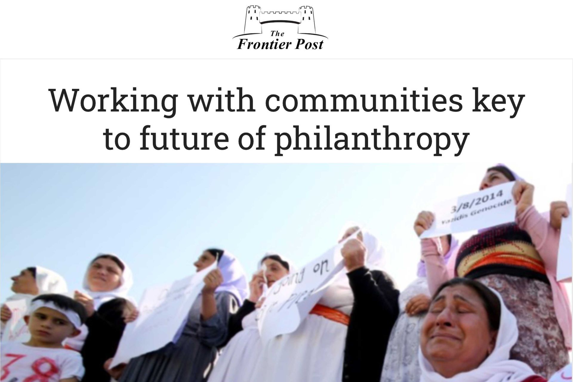 FrontierPost article with women holding signs. Headline reads “Working with communities key to future of philanthropy.”