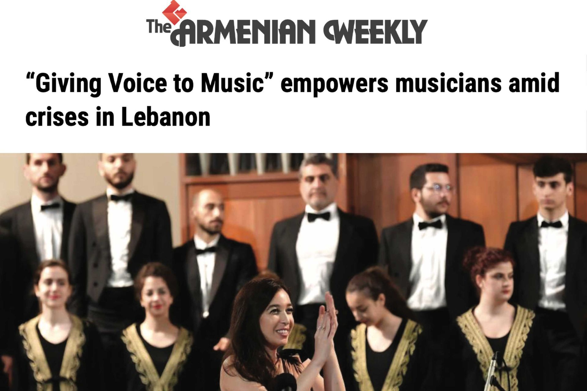 The Armenian Weekly feature; Lynn Zovighian  clapping at Giving Voice to Music concert. Fayha National Choir in background.
