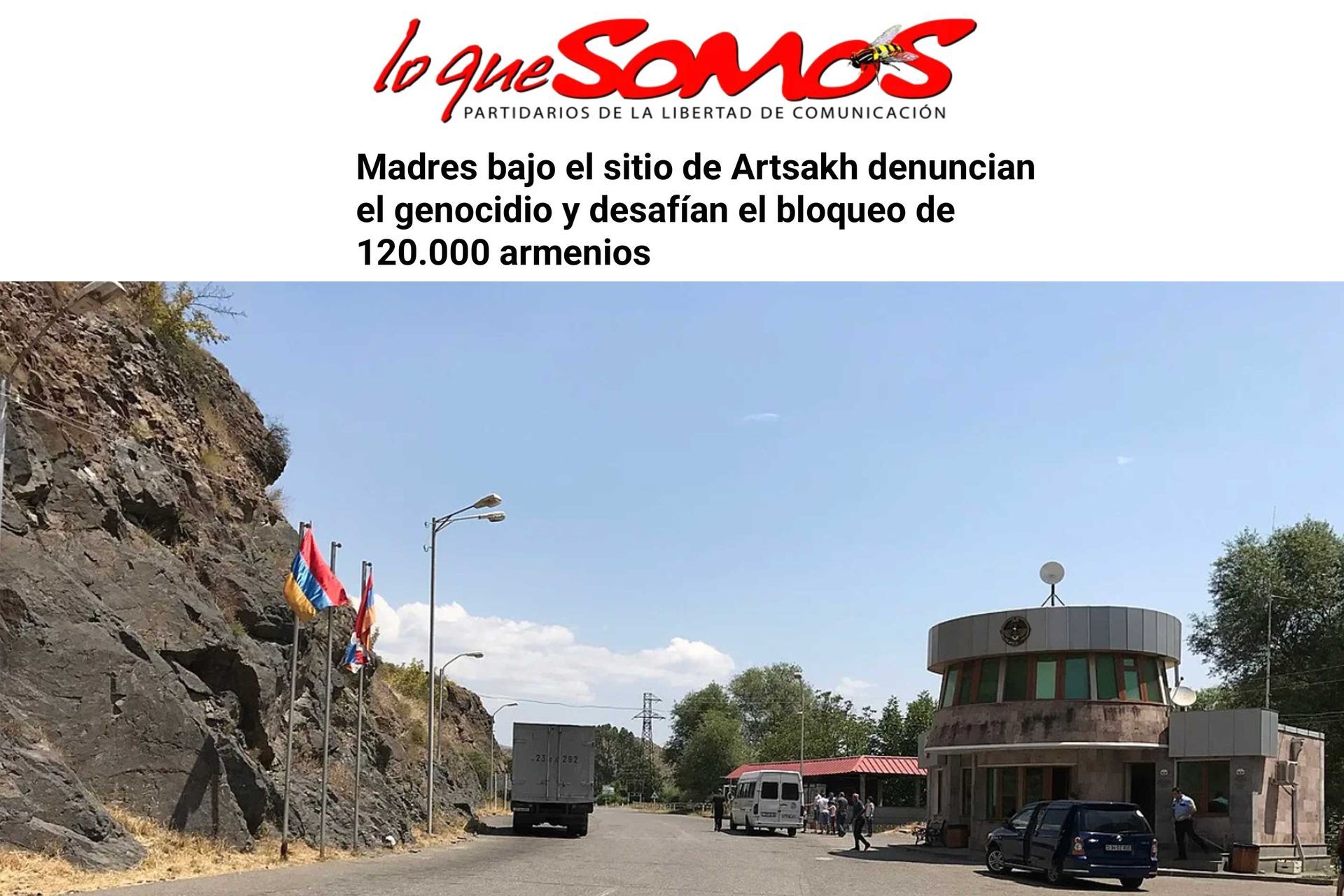 LoQueSomos Spanish-language feature showing a road with a rock wall, flags, and a building; headline about Artsakh mothers.