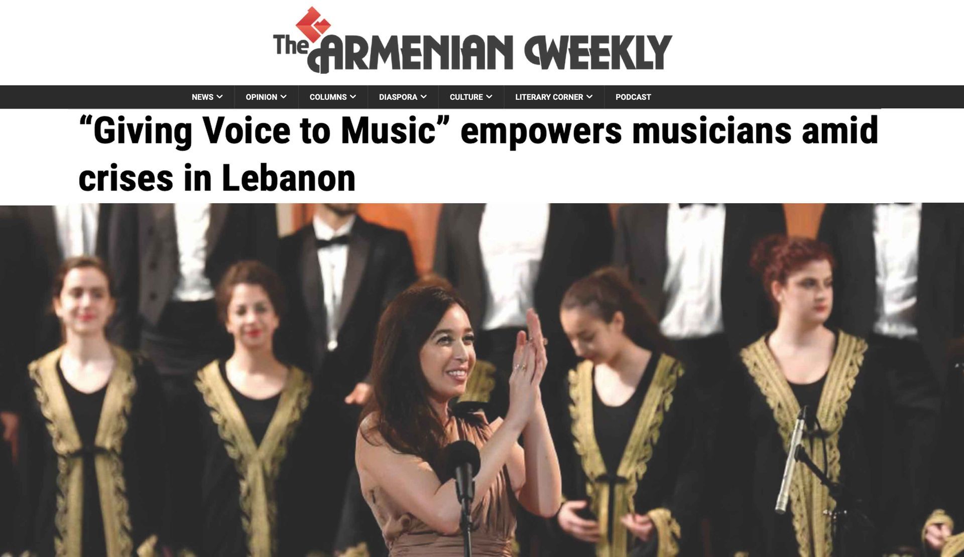The Armenian Weekly feature; Lynn Zovighian clapping at Giving Voice to Music concert. Fayha National Choir in the background