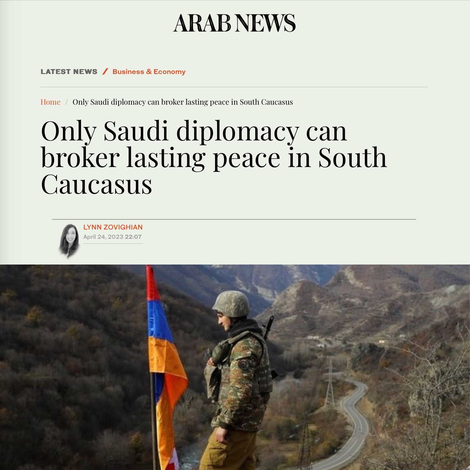 A soldier with an Armenian flag, overlooking a road and mountains, under an Arab News article headline by Lynn Zovighian.