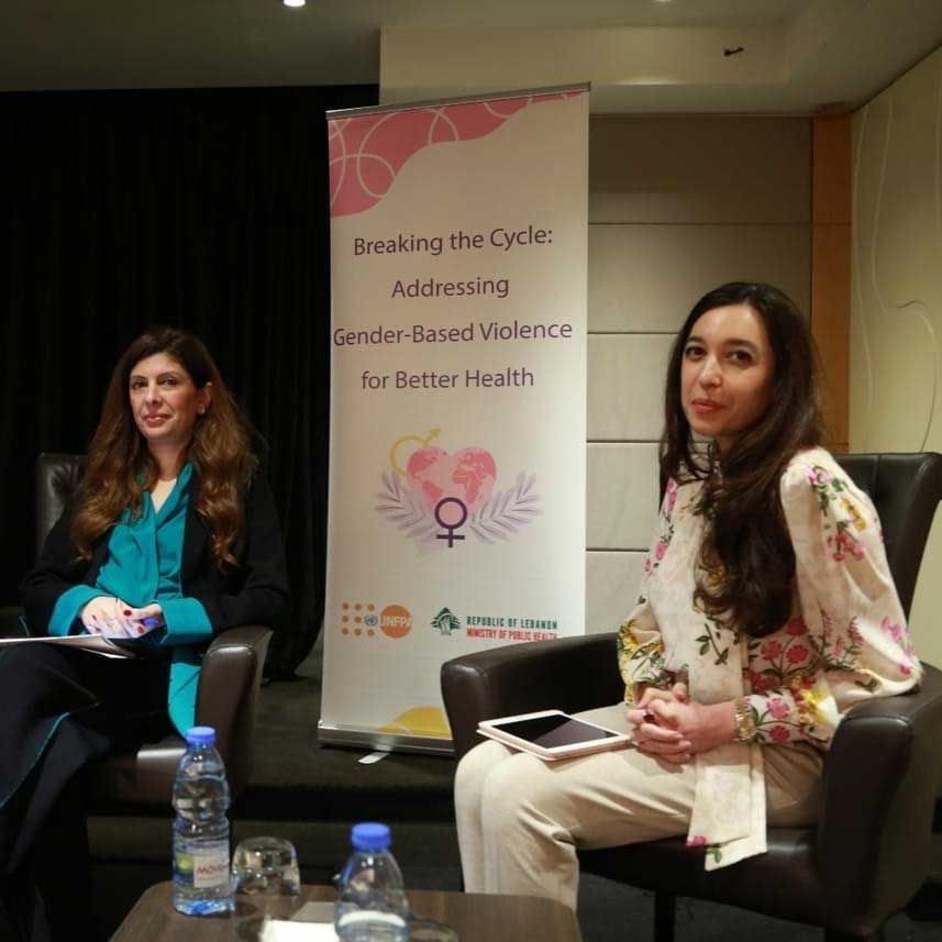 Lynn Zovighian In a UNFPA & MOPH policy session. Banner behind her reads Addressing gender-based violence for better health.