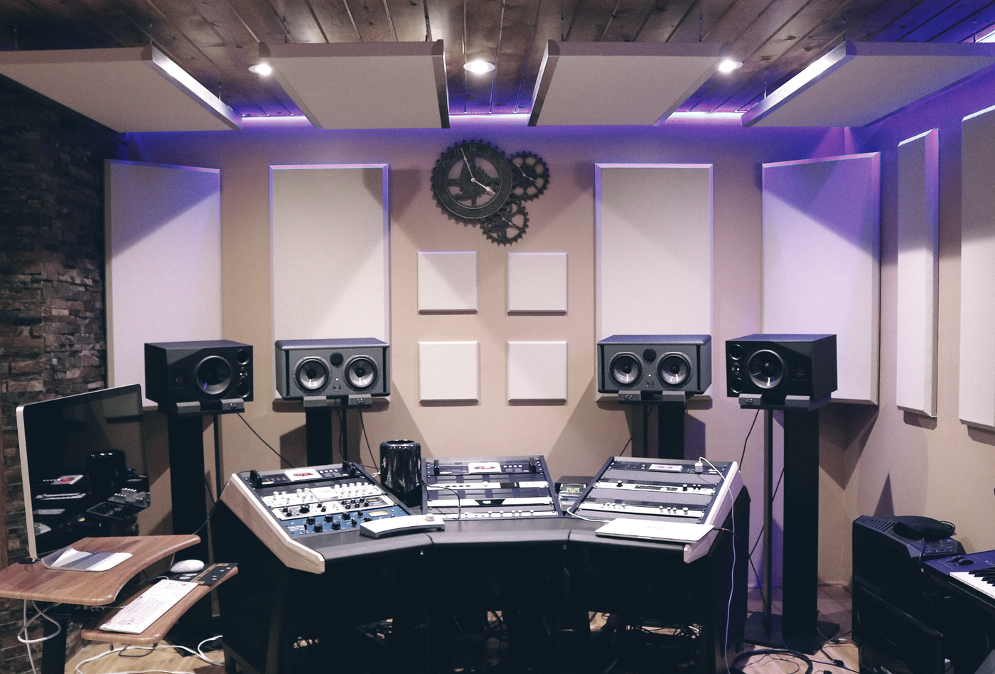 A recording studio with a purple light on the ceiling