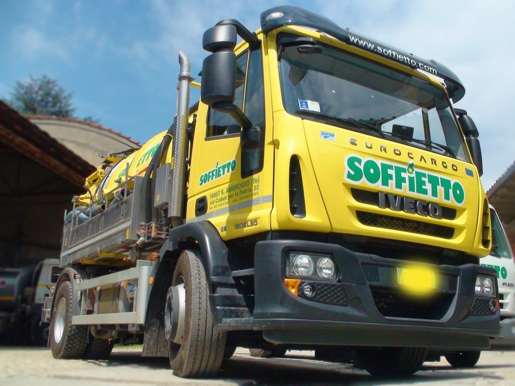 Un camion Iveco Eurocargo giallo per la pulizia delle fognature, parcheggiato all'aperto, con la scritta 
