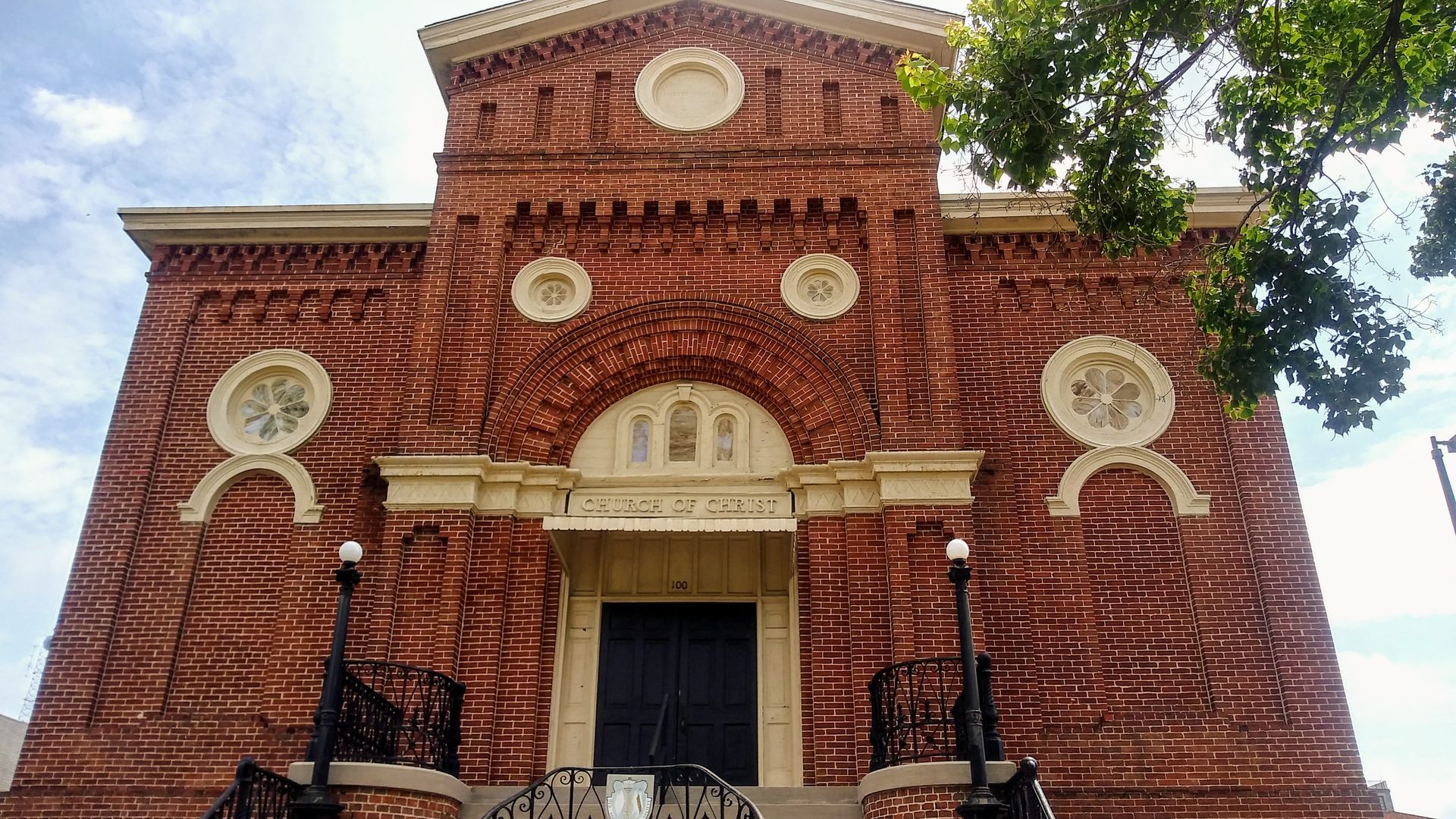A large brick building with a clock on the front of it.