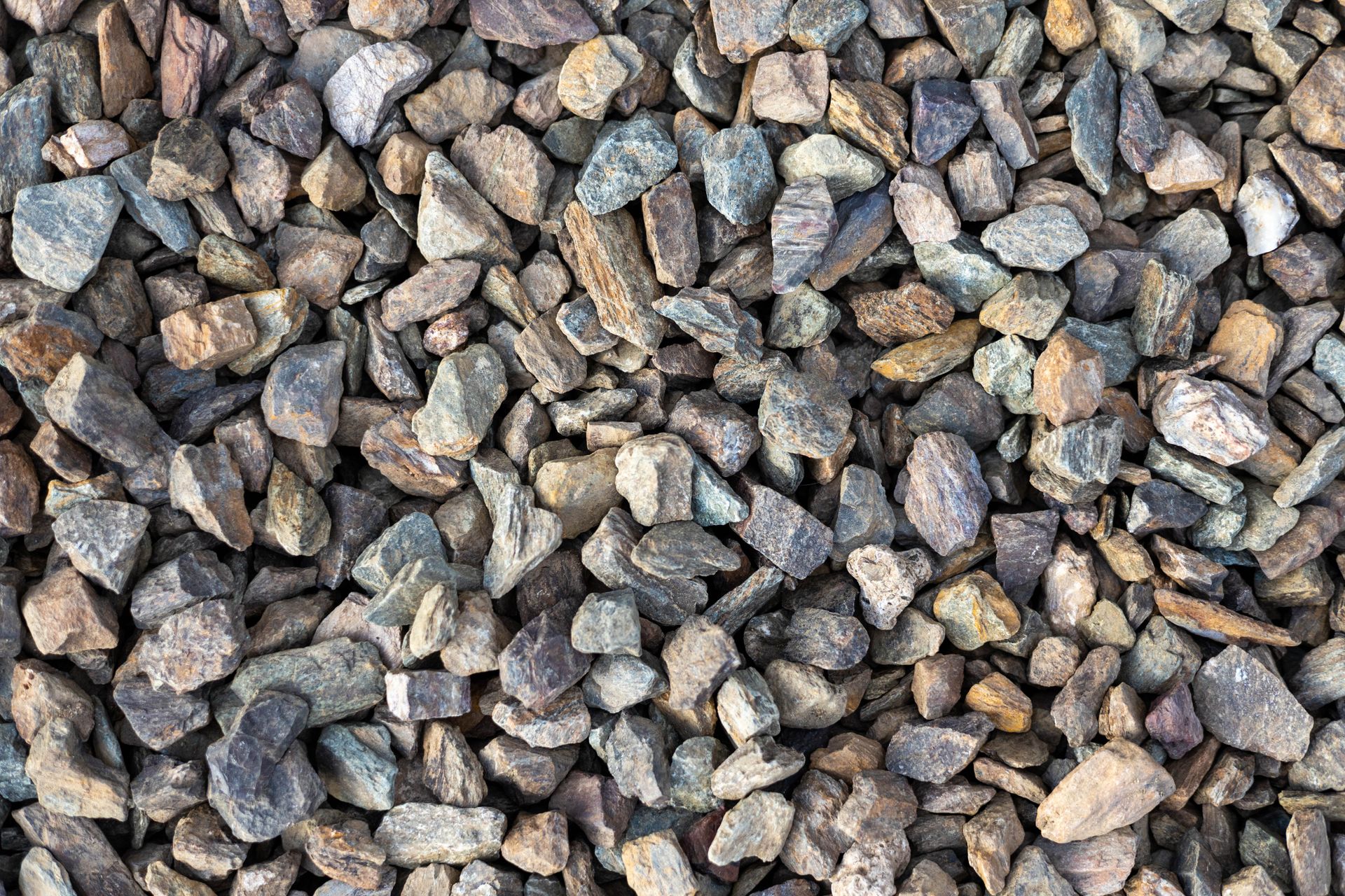 Close-up of small gray and brown gravel stones covering the ground